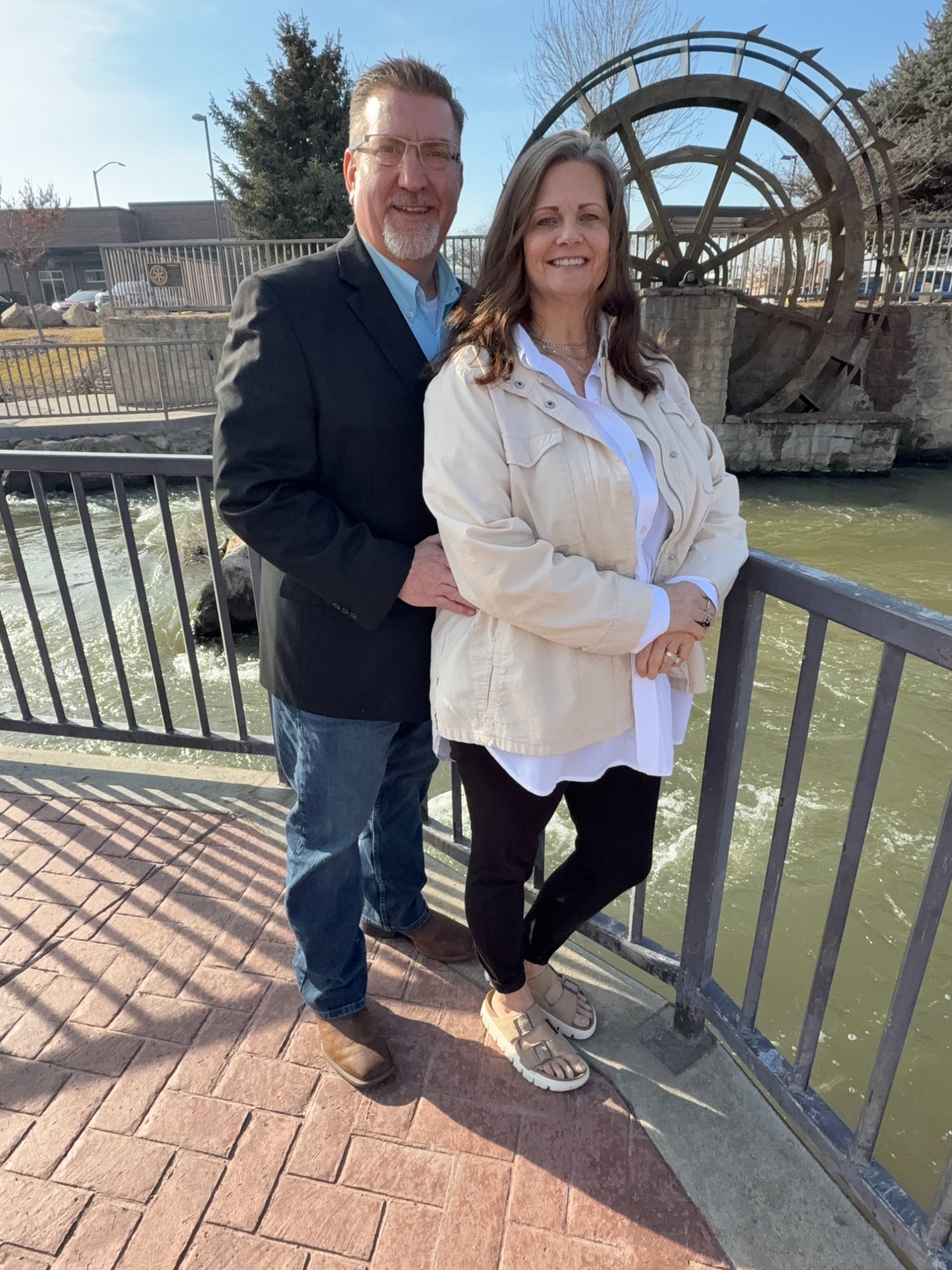 Troy and Suz Hooper outdoors by the watermill